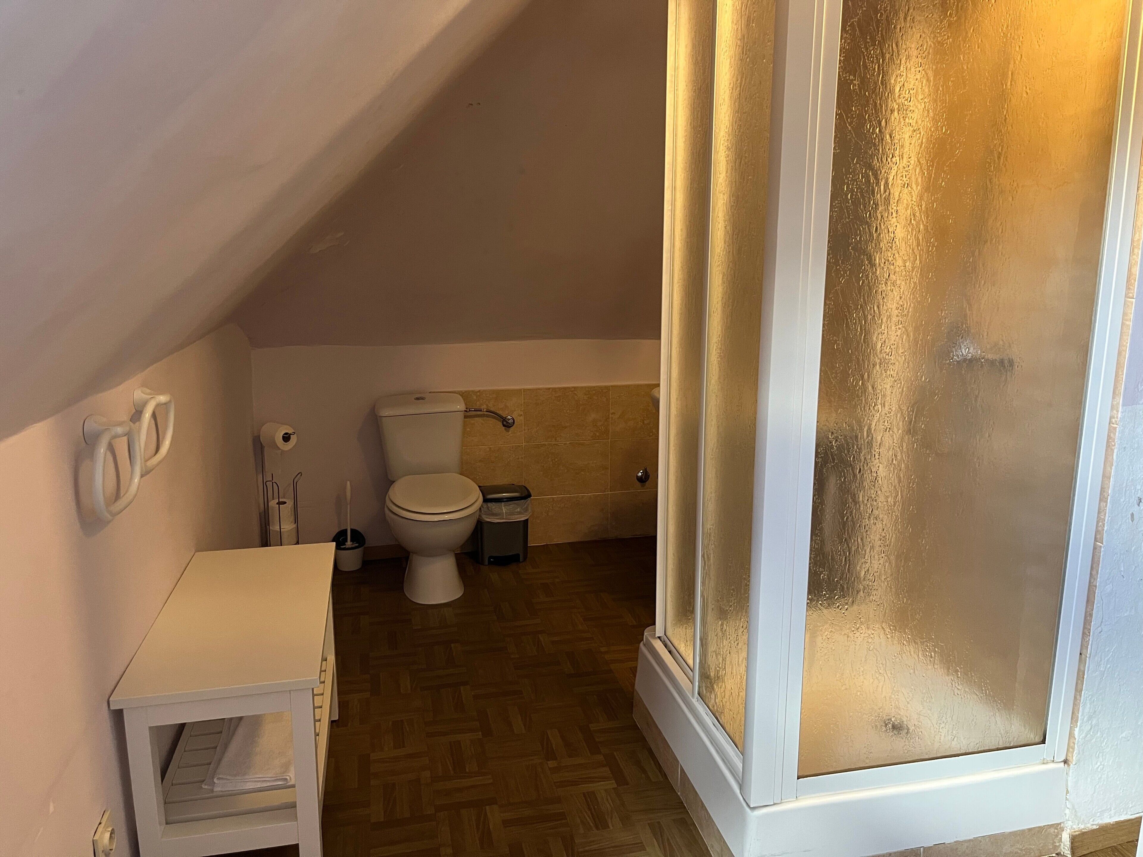 A small, compact bathroom with a toilet, bidet, and a small sink.