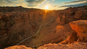 A canyon with a winding road and a clear sky. -  Pana Unique Charyn (Charyn Canyon)
