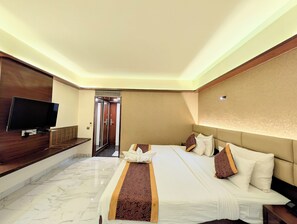 A hotel room with a bed, a TV, a bathroom, and a hallway. - Solaris Hotel and Club (Indore)