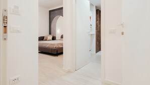 Un dormitorio moderno con una cama, un espejo grande y un armario.