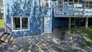 A two-story house with a blue exterior, a front porch, and a visible staircase leading to the upper floor. - Elegant & Serene Urban Sanctuary (Halifax)