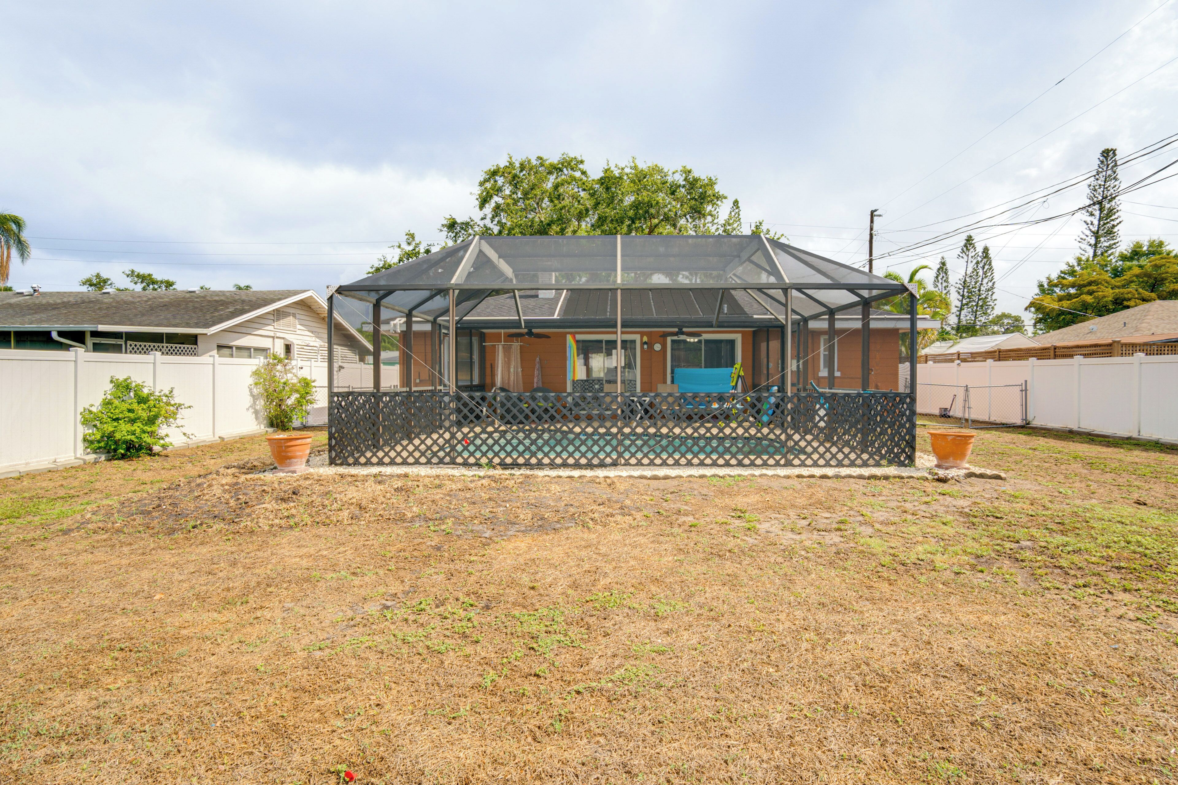 A house with a covered porch, a front door, and a fenced yard.