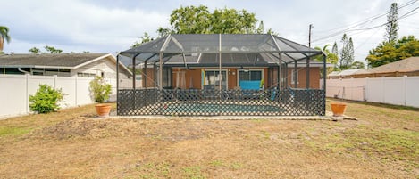 A house with a covered porch, a front door, and a fenced yard.