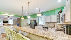 A modern kitchen with white cabinets, granite countertops, and stainless steel appliances. - Golf Course On-site: Spacious Hollidaysburg Home! (Hollidaysburg)
