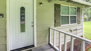 A house with a white door, a small porch with a white railing, and a window with shutters. - 14 Mi to Downtown Baton Rouge: Plaquemine Retreat (Plaquemine)