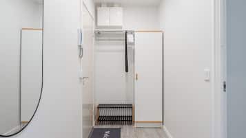 A narrow hallway with a radiator, a towel rack, and a door with a handle.