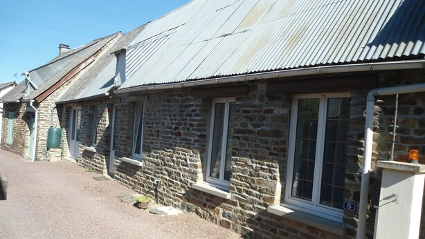 A row of stone buildings with metal roofs and windows. - Gîte in the heart of Suisse Normande  (Saint-Pierre-du-Regard)
