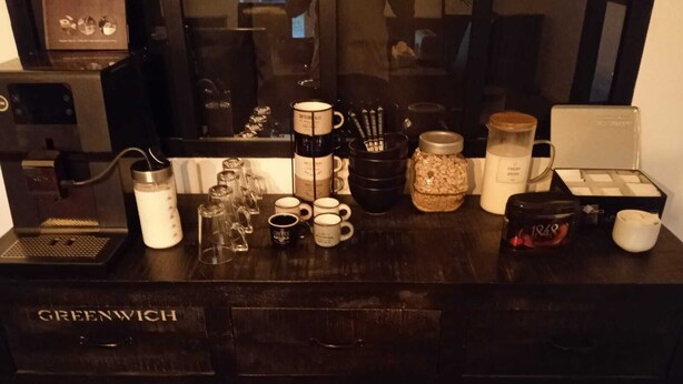 A coffee shop counter with various coffee-making equipment and containers. - Blue room 4 persons (Poyanne)
