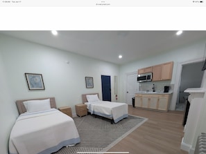 Standard Studio, 2 Twin Beds | Living area | 55-inch Smart TV with digital channels, streaming services