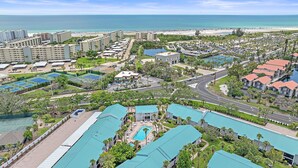 A resort with multiple buildings, a large pool area, and a beach view. - White Sands On Siesta 1 Bedroom Condo (Siesta Key)