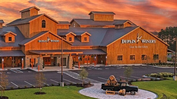 A wooden building with the name "Dupin Winery" and a slogan "God be the Glory". - 17007 Firenzo Ave 3 Bedroom Home (Panama City Beach)