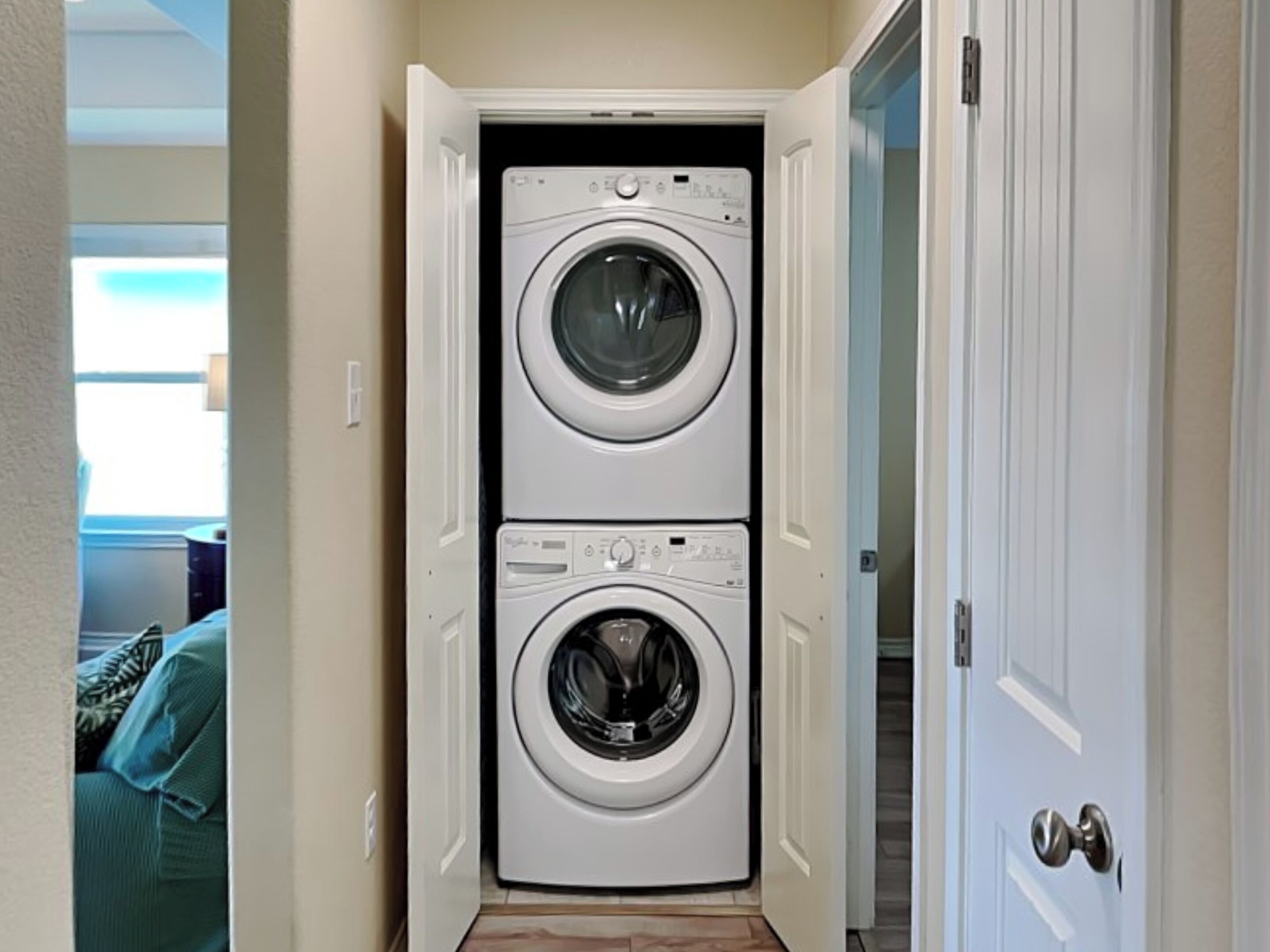 A laundry room with two stacked front-loading washing machines.