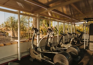 A gym with treadmills, elliptical machines, and weight equipment. - Maspalomas Villas by Dunas - Only Adults (San Bartolome de Tirajana)