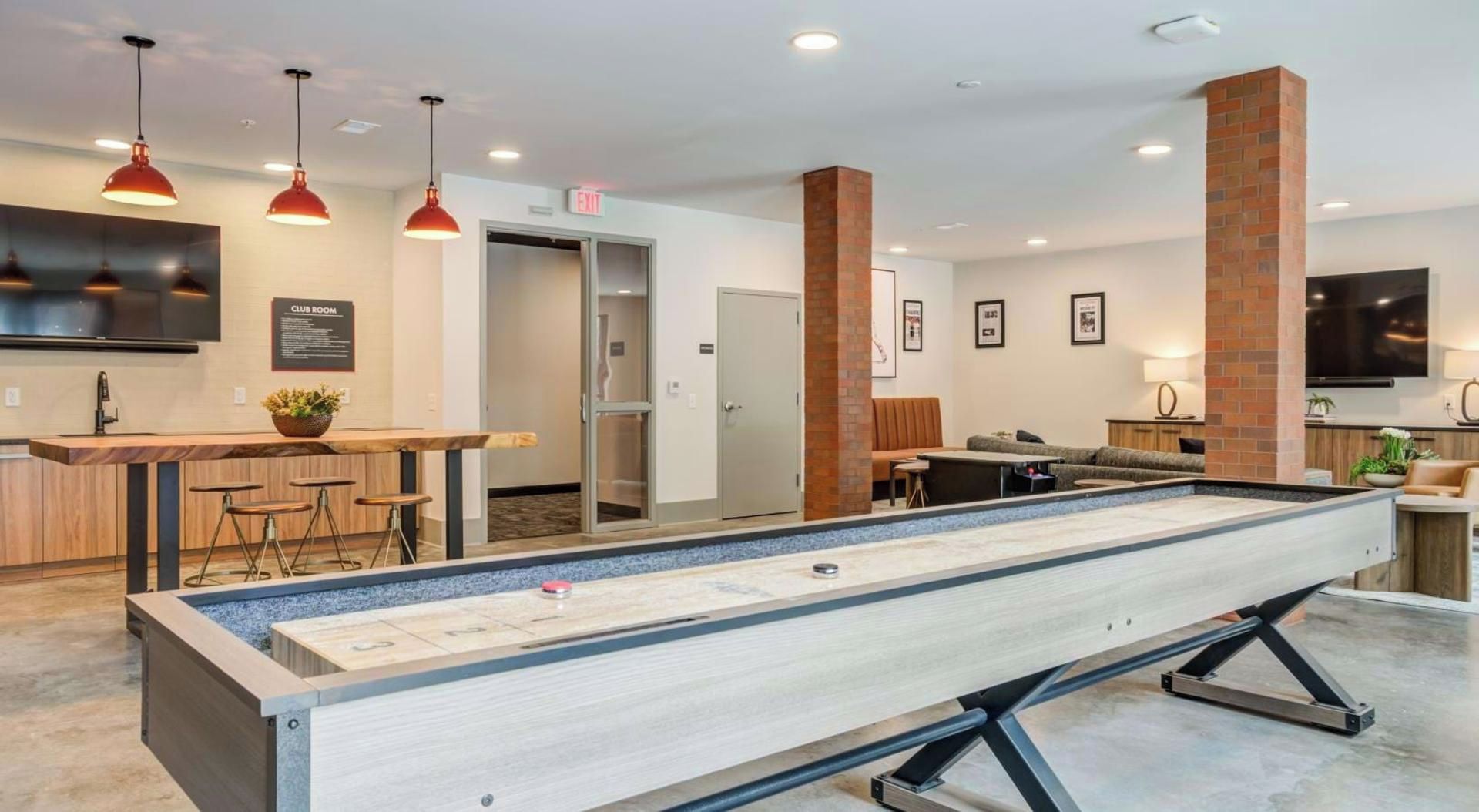 Ein Billardtisch in einer Hotel-Lounge mit Bar und Sitzgelegenheiten.