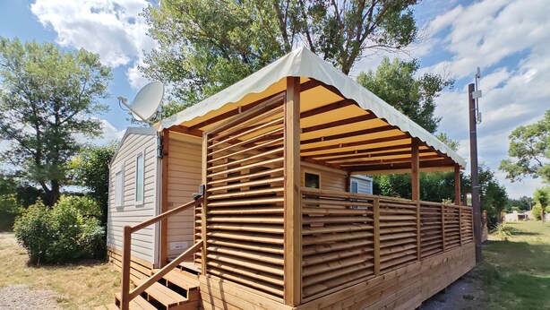 A wooden cabin with a covered porch and a satellite dish. - Bungalow Privas (AZALÉE (Unknown)