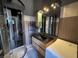 Shower, hair dryer, towels, toilet paper