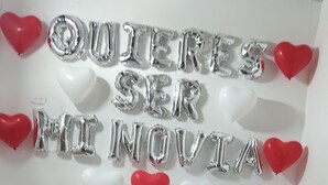 A bed with a bouquet, rose petals, and silver balloons spelling out a message. - Finca Hotel La Moni (Circasia)