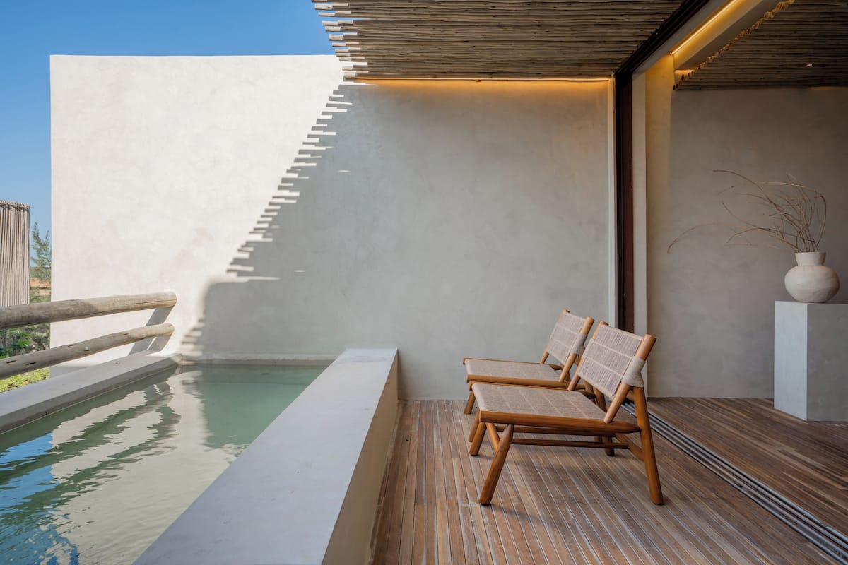 A poolside area with wooden loungers and a clear view of the pool.