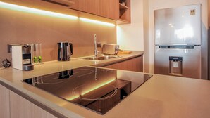 A modern kitchen with a built-in induction cooktop, stainless steel appliances, and a water dispenser. - Impresionante Depto en Buenos Aires D907 (Buenos Aires)