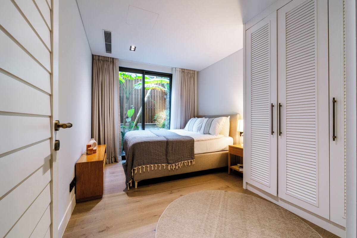 Premium bedding, desk, laptop workspace, blackout drapes