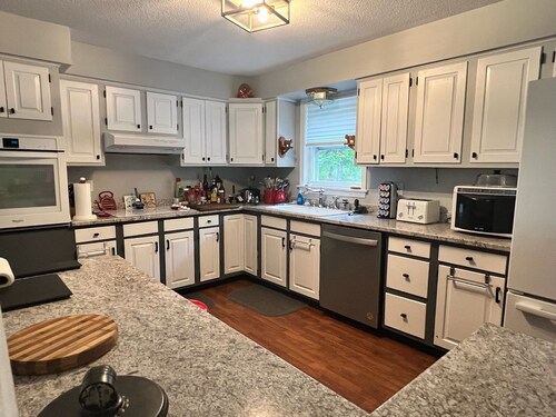 Spacious five-bedroom home off Back Lake with direct trail access on Spooner Rd