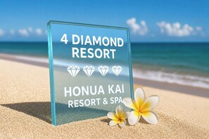 A sign for 4 Diamond Resort on a beach with a clear sky. - Honua Kai | Ocean View 4 BR, Sleeps 14 | Car Incl. w/ 6+ Nights | HKH ML-1351 by KBM (Lahaina)