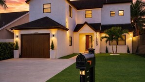 A two-story house with a mailbox in the front yard.