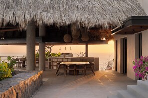 Outdoor dining - Luxury home on the cliffs of Zihuatanejo. Catering, gym, sauna, barbecue. (Gro.)