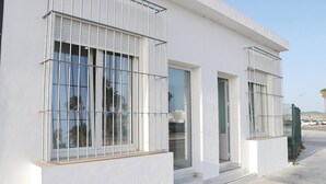 A modern building with large windows and a white facade.