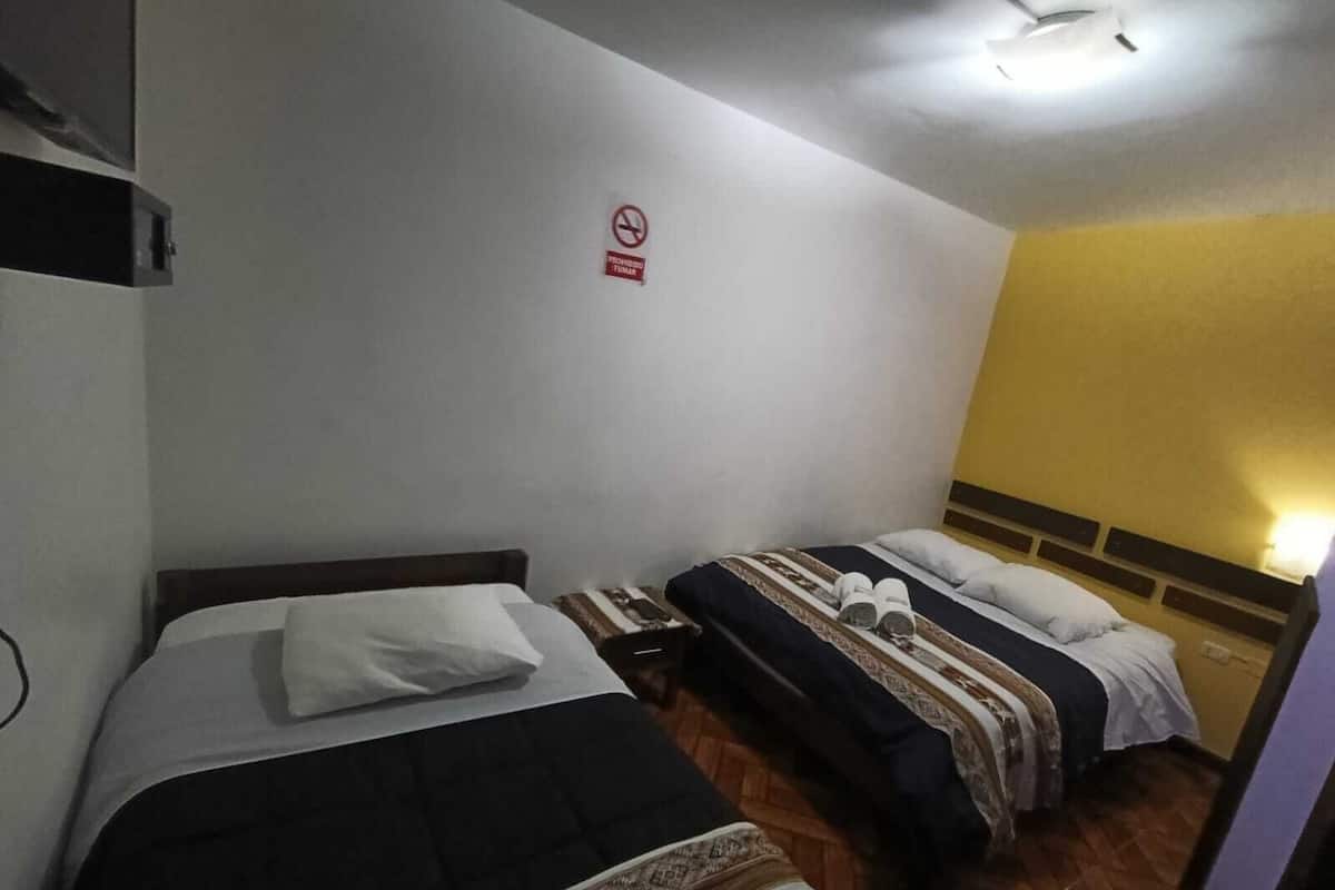 Economy Triple Room, Courtyard View | Laptop workspace, blackout drapes, iron/ironing board, free WiFi