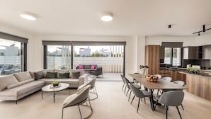 A modern apartment with a living area, dining space, and kitchen.