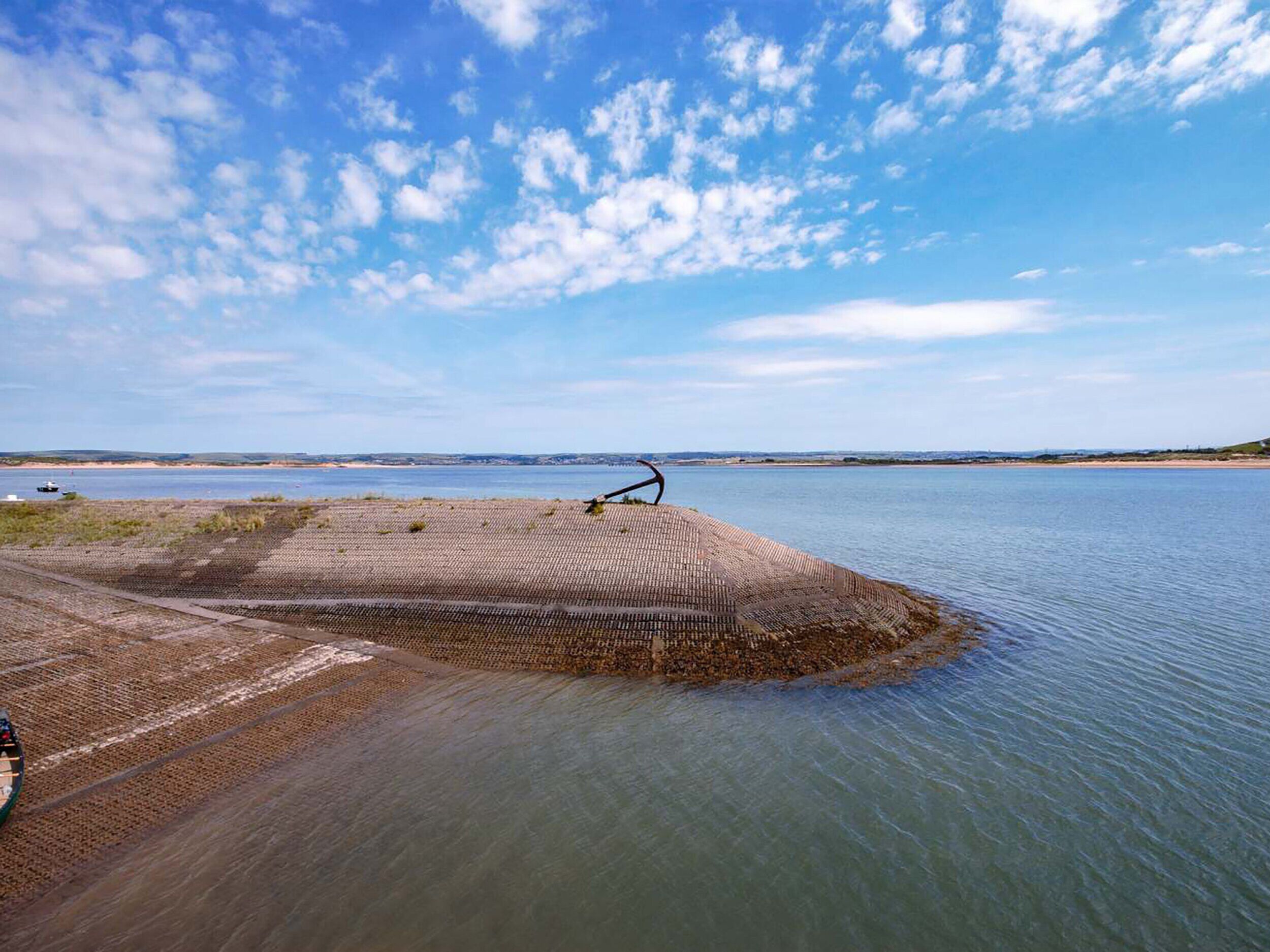 A coastal area with a sandy beach and a large body of water.