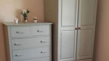 A white dresser with drawers and a cabinet with two doors.