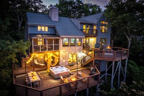 A two-story house with a deck, hot tub, and outdoor seating area. - Wintergreen Luxury, Breathtaking Views (Wintergreen Resort)