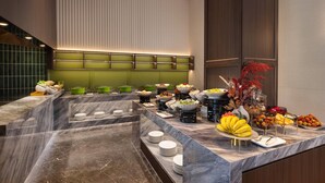 A buffet setup with various food items and dishes, a marble countertop, and a green wall with vertical lines. - Days Hotel By Wyndham Suzhou Dushu Lake (Suzhou)