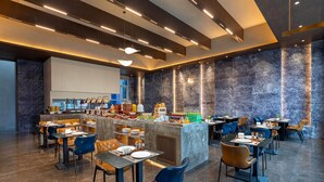 A modern restaurant with a central bar, multiple seating areas, and a marble wall. - Days Hotel By Wyndham Weihai Huoju Eight Street (Weihai)