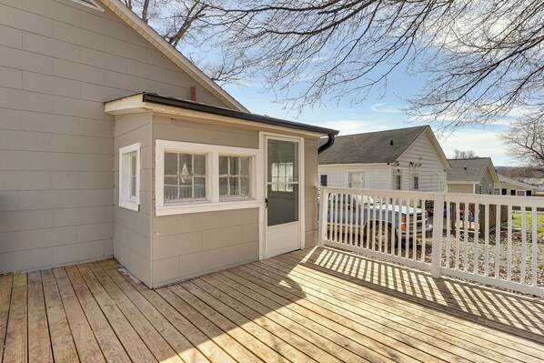 A deck with a white railing, a small shed, and a garage door. - Close to Shops, Eats & Hospital: Roxboro Retreat (Roxboro)