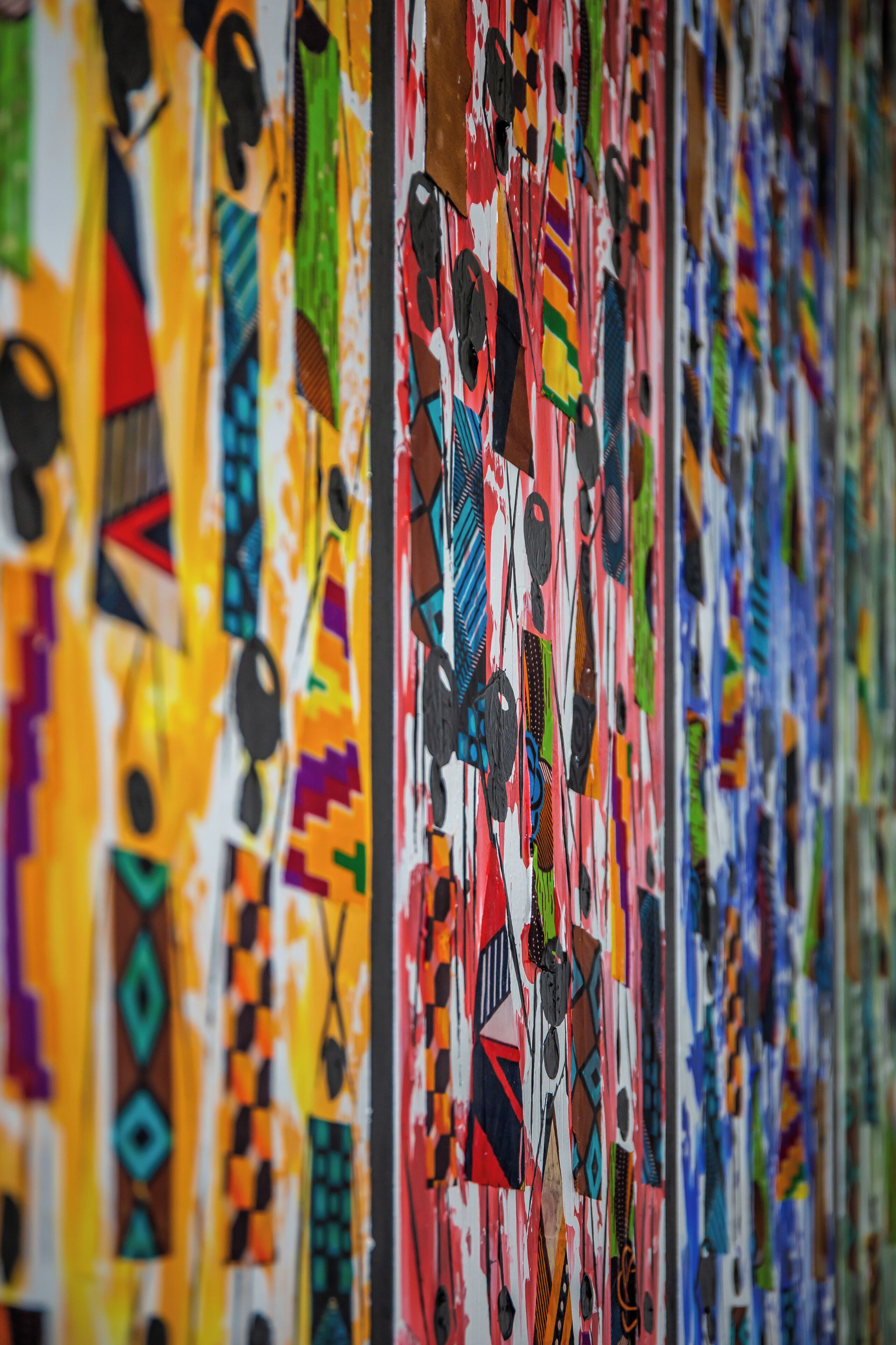 Una pared con diversos patrones y diseños abstractos y coloridos.