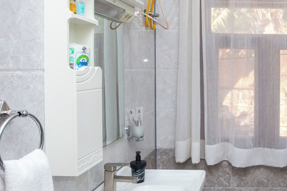 A bathroom with a white sink, mirror, and towel rack.
