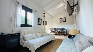 A bedroom with a bed, a desk, and a chair.