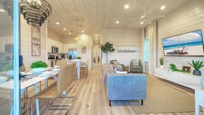 A modern interior with a kitchen, dining area, and living space. - Private Pool, Fire Pit, Beach Boardwalk Access, Views The Madison by Avantstay (Port Aransas)