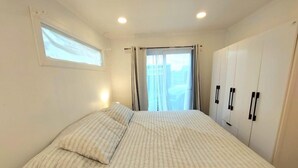 A bedroom with a bed, a window, and a wardrobe. - Lindas Cabañas En Puerto Varas (Puerto Varas)