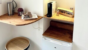 A compact kitchenette with a coffee maker, a kettle, a jar of condiments, and a box of cookies. - MIRA - Casa di Mare is a bright retreat in the heart of Polignano a Mare. (Polignano a Mare)