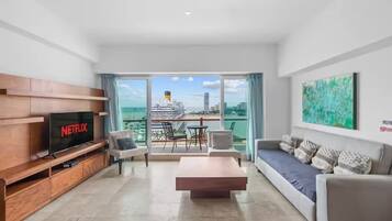 Apartment | Living area | 65-inch Smart TV with cable channels, offices