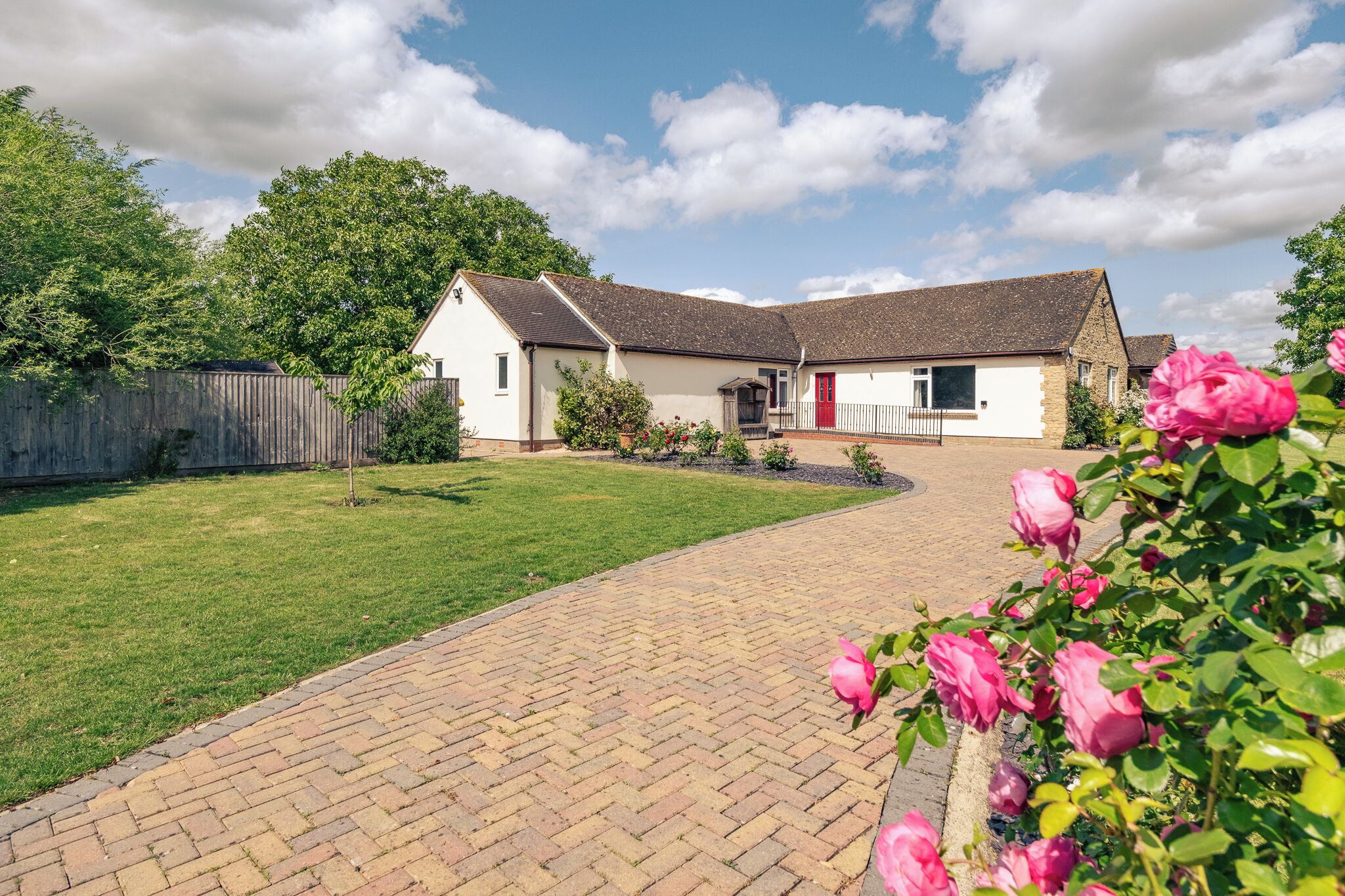 A single-story house with a brick pathway leading to the entrance.