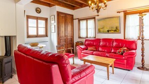 A living room with red leather sofas, a wooden coffee table, a fireplace, and a chandelier. - LEGENT - GRESY SUR AIX (GRESY SUR AIX)