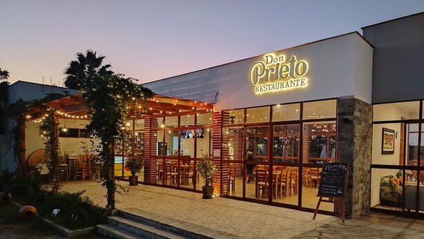 A restaurant named Don Prieto Restaurante with outdoor seating and string lights. - Hotel La Colina Live the experience among dunes and nature (Cerro Prieto)