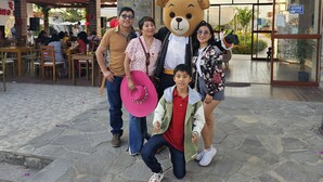 A group of people posing in front of Don Prieto Restaurante and La Colina Hotel. - Hotel La Colina Live the experience among dunes and nature (Cerro Prieto)