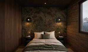A bedroom with a bed, two bedside tables, and a large window.