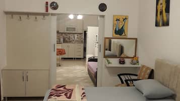 Comfort Quadruple Room, Multiple Beds, Patio, Garden View | Laptop workspace, iron/ironing board